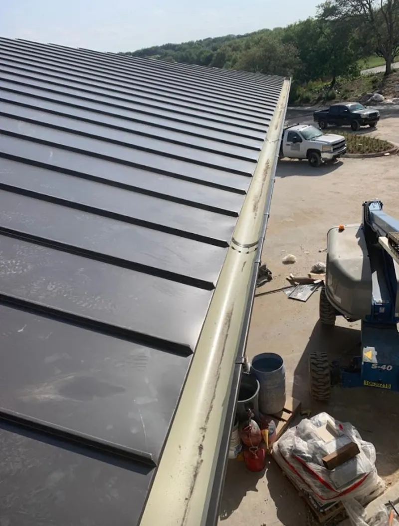 Standing seam panel and gutter detail on a metal roofing jobsite in Castle Pines Village